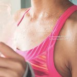 Female wearing a bright pink tank top perspiring on her chest.  With a Zitout Fit pimple patch on her chest. With a tagline, customizable FIT patches for hard-to-reach areas.